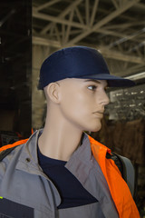 Cap dark blue color, workwear gray orange color worn on a mannequin. Construction, medicine, protective equipment.