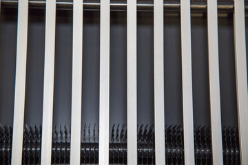 Metal grating of steel color with horizontal stripes, backgrounds, textures, design.