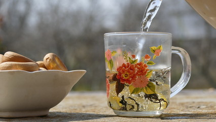 Making hot tea with lemon. Pour boiling water into a cup.