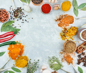 A variety of spices and herbs on a light table. Cooking background. View from above. Ingredients for cooking. Table background menu. Copy space.