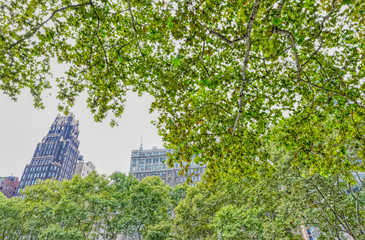Surrounding buildings and skyscrapers visible from the Bryant Park during the gloomy weather in Manhattan, New York
