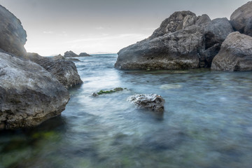 Fototapeta na wymiar Long exposure shot at shores of Capri Island in Italy
