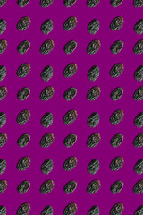 Seamless pattern on a purple background raisins background. Top view.