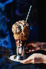 Cookies shake in graffiti place. Extravagant and crazy milkshake with ice cream and chocolate. Special for kids. Insane dessert. Famous in America. Full of calories. - 337061600