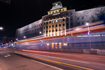 Fototapeta na wymiar Traffic light trails in front of the largest Post office in Serbia
