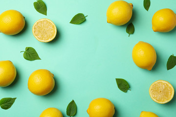 Fresh lemons on mint background, top view. Ripe fruit