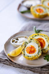 Scotch eggs wrapped with smoked haddock and cod