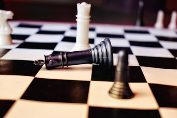 Chess game going on where black king is fallen down