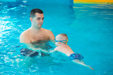 occupation in the pool of children with a swimming coach.