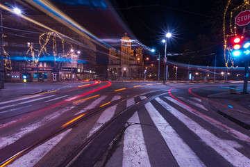 Fototapeta na wymiar Saint Mark's church at night and light trails from passing trams and buses in Belgrade