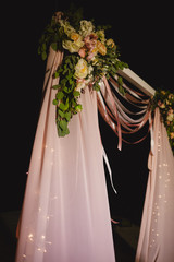 arch for the wedding ceremony, decoration cloth flowers greenery, Wedding arch with light bulb outdoors. selective focus