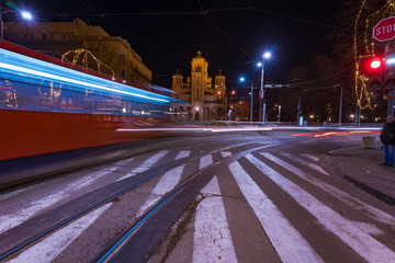 Fototapeta na wymiar Long exposure of Saint Mark's church at night and light trails from passing vehicles