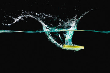Lemon surfing in water and splashing