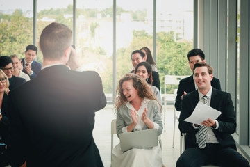 Fototapeta premium Group of business people sitting on conference together listening to the speaker giving a speech in the meeting room seminar, The talker motivating, cheer up and giving inspires poeple