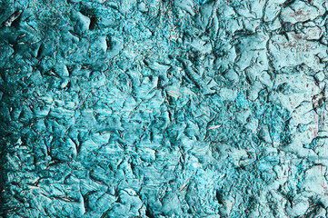 The door is turquoise. flaky bark