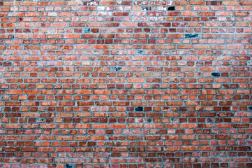 Large brick orange wall of a building.
