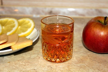 Alcoholic drink poured into a transparent glass in combination with lemon