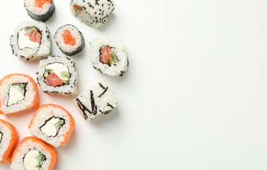 Delicious sushi rolls on white background, top view. Japanese food
