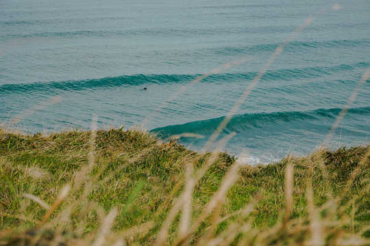 Magical view of the Atlantic Ocean with Waves and some Surfers. Sea views from above of a hill