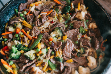Mixed vegetables and meat stir fried together in the frying pan