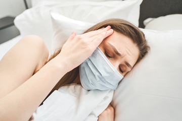 Ill blonde woman having a severe headache