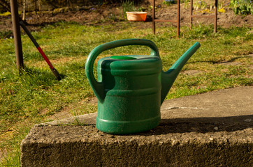 Green watering can, ax, garden things, time for garden work