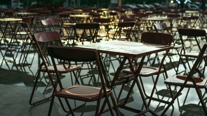 Red tables and chairs on the outdoor. Cafe. City after rain concepts.