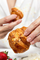 Unrecognizable woman having breakfast in pajamas at home in quarantine