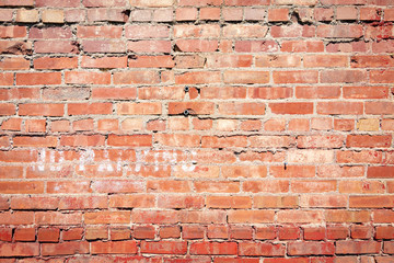 Naklejka premium Old brick wall in back lot.