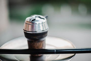 Obraz premium Metal hookah on a summer terrace with a blurred background