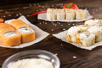 Sushi rolls with salmon, sushi rolls with mushrooms and sushi rolls with bell pepper