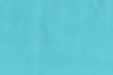 Turquoise soft fabric. The texture of the plain fabric for the dress