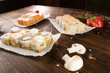 Sushi rolls with salmon, sushi rolls with mushrooms and sushi rolls with bell pepper