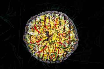 Tasty pizza on black background. Top view of hot pizza.