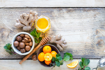 Healthy products for Immunity boosting on wooden background with copy space top view. Lemon, nuts, ginger to immune system