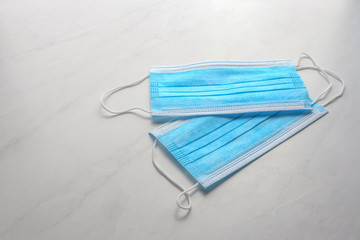 Disposable face mask on light background