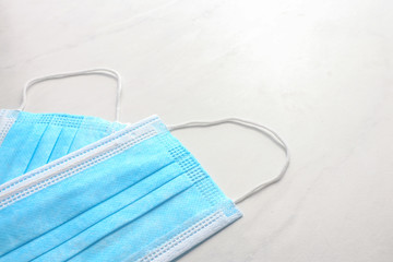 Disposable face mask on light background