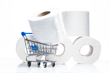 Grocery shopping cart with Toilet Paper rolls behind. Concept of lack of toilet paper in stores due to coronavirus, Covid-19