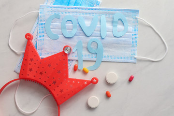 Composition with disposable face mask, decorative crown and sign 