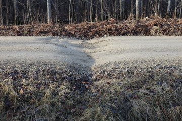 Gravel road, frost heave and dip at center line culvert

