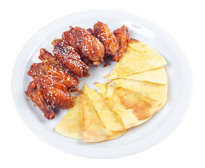 chicken wings in spicy sauce. popular pub dish. beautiful junk food concept. isolated on a white plate.