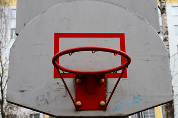 Outdoor basketball hoop with torn net bottom view