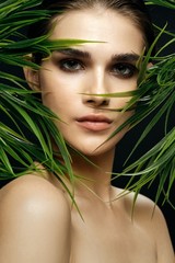 beautiful woman green leaves exotic nature