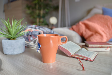 cup of tea on table with books