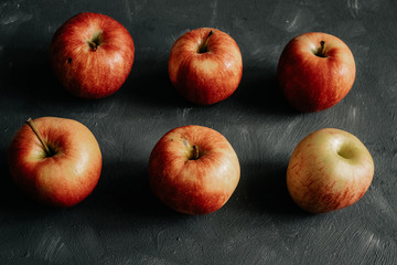 
Red apples on black background.