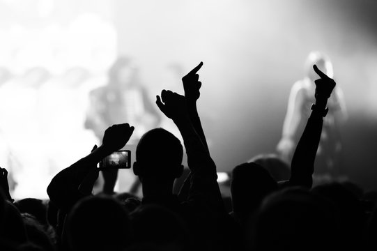 monochrome photo of hands with gestures from the crowd at a music concert. rock festival banner. emotions on your favorite songs