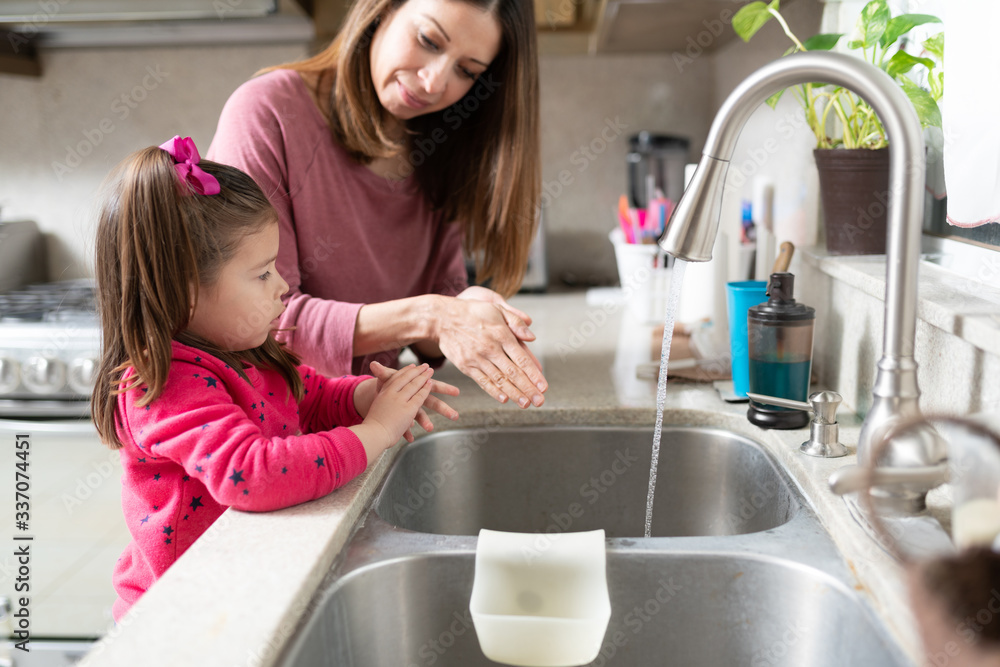 Wall mural washing hands together at home