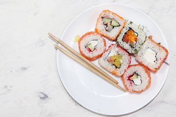 Fresh sushi rolls on a light background, top view, copy space