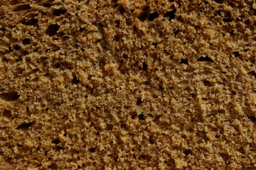 Dark bread texture background. Food, bakery concept. Cropped shot of bread, horizontal view.