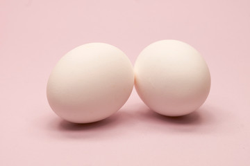 two eggs on a pink background